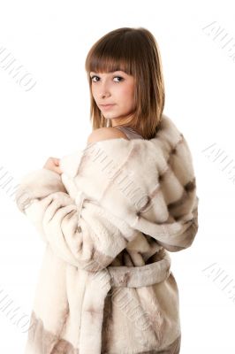 A beautiful young girl in a fur coat
