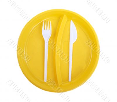 Yellow plastic plate, fork and knife
