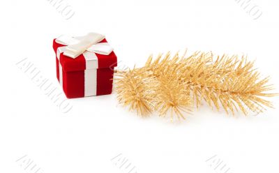 Red and gold gift box with fir branches