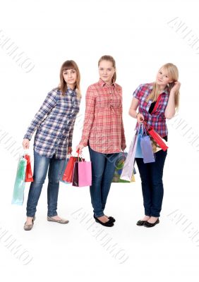 Three girls with colorful shopping bags