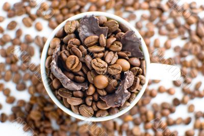 white cup with coffee beans