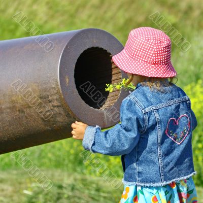 Little girl, gun and yellow flowers