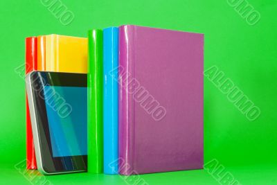 Row of colorful books and tablet PC Row of colorful books and tablet PC