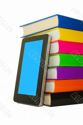 Stack of colorful books and tablet PC