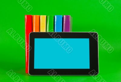Row of colorful books and tablet PC