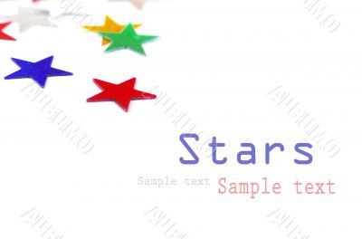 Christmas decoration of colored confetti stars against white bac