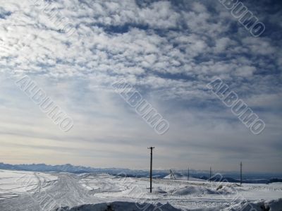 Blue sky with a little clouds and winter caucasus mountain lands Blue sky with a little clouds and winter caucasus mountain lands