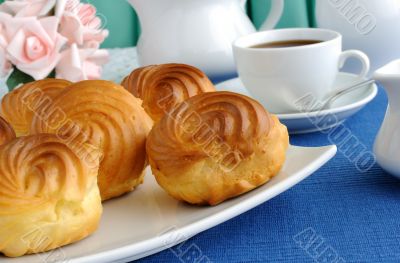 Eclairs with a cup of coffee