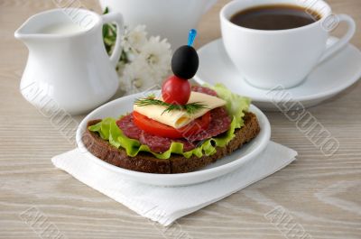 Sandwich with a cup of coffee and milk