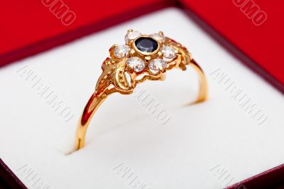 Gold ring with white and blue zirconia enchased