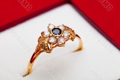 Gold ring with white and blue zirconia enchased