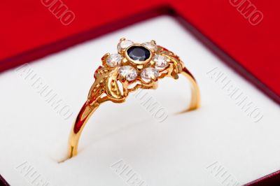 Gold ring with white and blue zirconia enchased