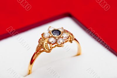 Gold ring with white and blue zirconia enchased