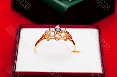 Gold ring with white and blue zirconia enchased