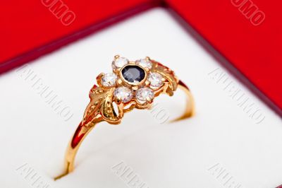 Gold ring with white and blue zirconia enchased