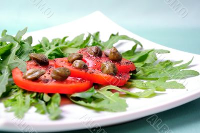 Salad with fresh tomatoes, capers and arugula