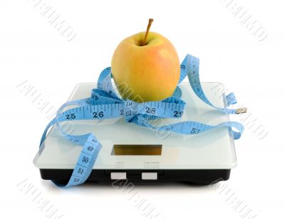 Apple on the scales measuring tape wrapped