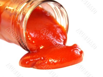 Tasty ketchup flowing out of the bottle isolated on white background 