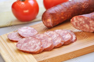Mouth-watering smoked sausage and ripe tomatoes 