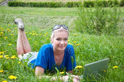 Young girl with laptop in the park