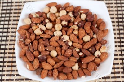 Roasted almonds and hazelnuts on a plate