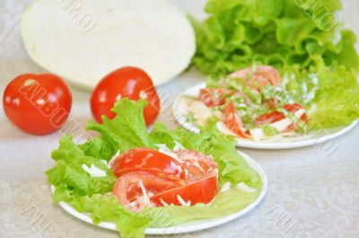 Tomatoes with mayonnaise on lettuce leaf