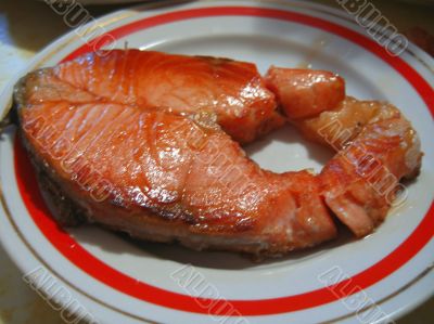Fried red fish steak on the white plate Fried red fish steak on the white plate