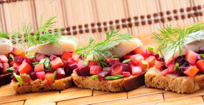 Sandwiches with rye bread, herring and vegetables