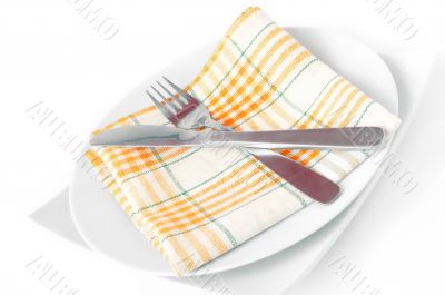 Napkin, folded on a plate with knife and fork 