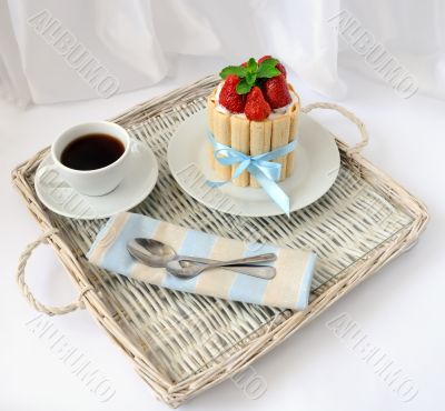 Dessert souffle with biscuit and fresh strawberries and a cup of