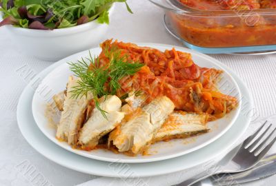 Baked fish in tomato sauce with vegetables