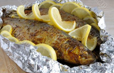 Baked herring in spices and herbs in foil