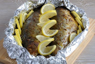 Baked herring in spices and herbs in foil