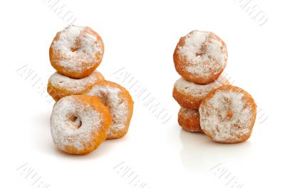 Fried donuts in powdered sugar on a white background