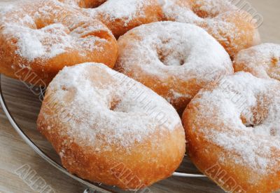 Fried donuts in powdered sugar closeup