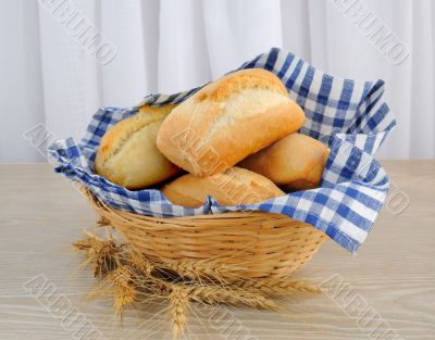 Fresh bread in a basket with a napkin shelter
