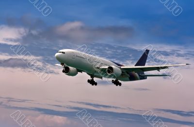 passenger plane comes in to land on a blue sky