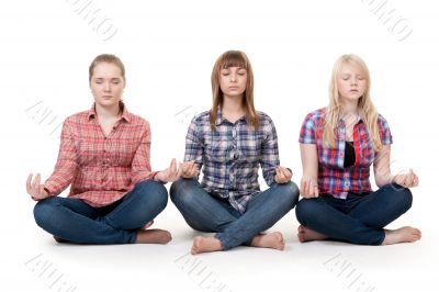 Three girls sitting in lotus posture