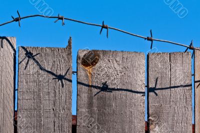 wooden fence of barbed wire