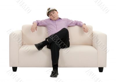 Serious young boy wearing a cap captain