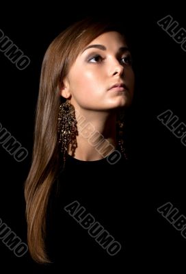 portrait of a girl`s face in the darkness.