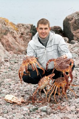 man with crabs in the Barents Sea coast