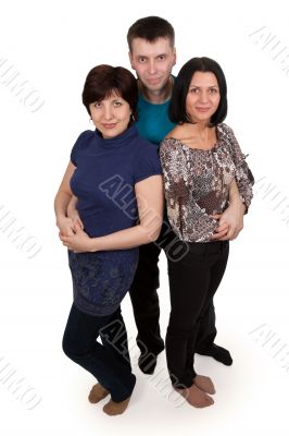 man hugging two women
