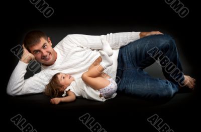 happy father with his little daughter lying