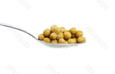 Spoon with green peas