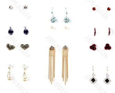 several pairs of earrings with stones