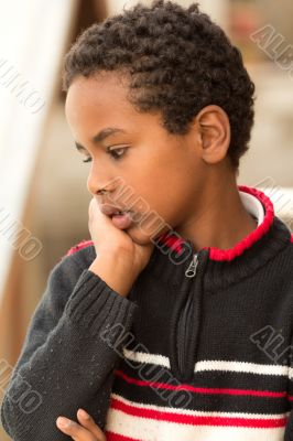 Portrait of an Ethiopian boy resting his chin on his hands