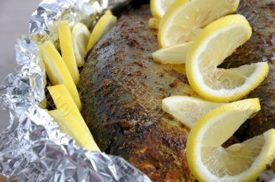 Baked herring in spices and herbs in foil