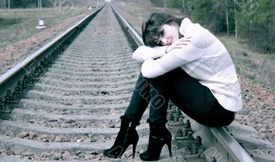 Young woman sitting on the rail