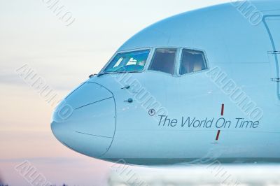 Front profile and cockpit windows of wide-body airplane